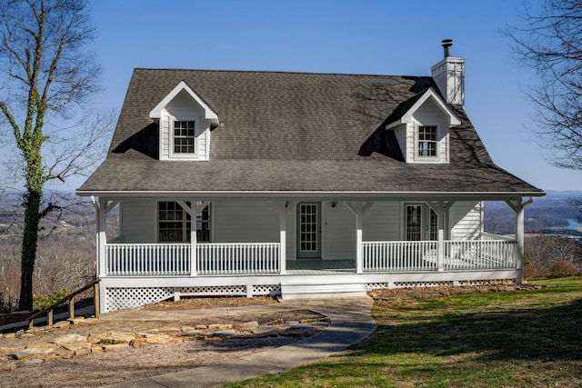 view of front of property featuring a shingled roof, a porch, and a chimney