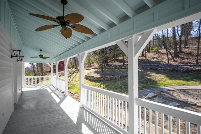 wooden terrace with a porch and a ceiling fan