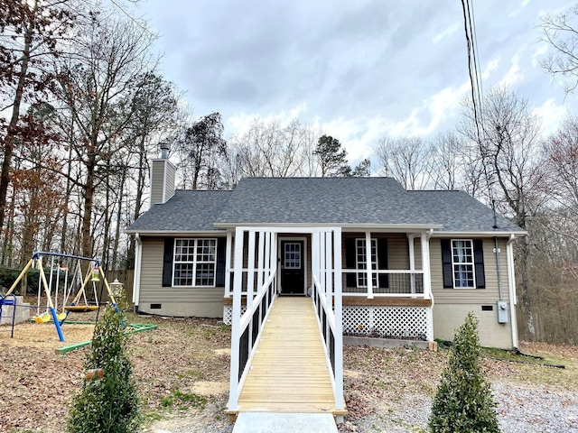 ranch-style house featuring roof with shingles, a porch, crawl space, and a playground