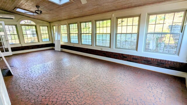 unfurnished sunroom featuring baseboard heating, a wall mounted AC, a ceiling fan, vaulted ceiling with skylight, and wooden ceiling