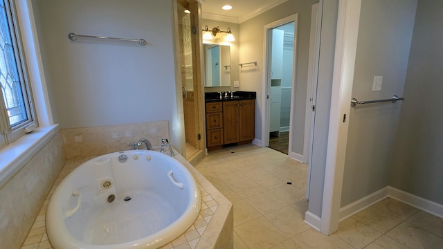 full bath featuring vanity, baseboards, ornamental molding, tile patterned floors, and a whirlpool tub