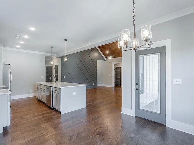 kitchen with stainless steel appliances, dark wood finished floors, light countertops, and ornamental molding