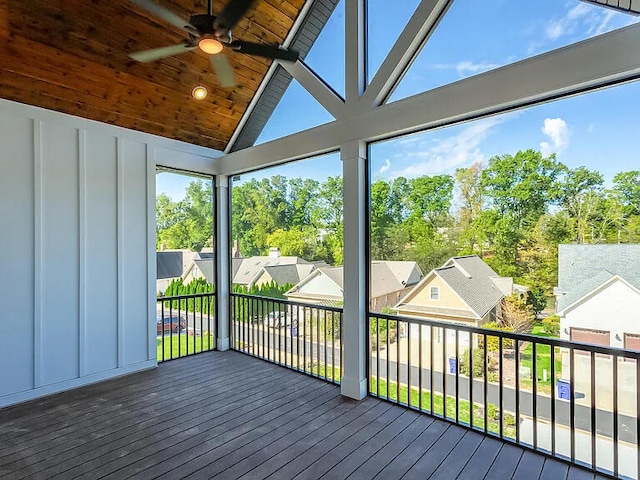 unfurnished sunroom with vaulted ceiling, ceiling fan, plenty of natural light, and wooden ceiling