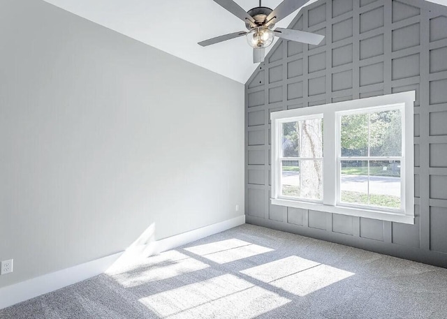 carpeted spare room featuring ceiling fan, high vaulted ceiling, and built in shelves