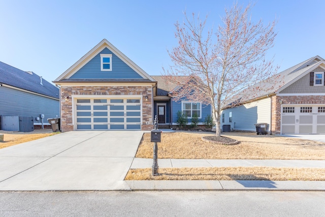 view of front facade with cooling unit, driveway, and an attached garage