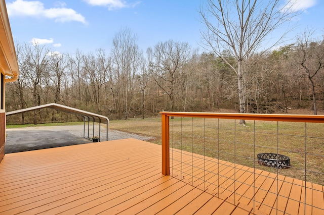 wooden terrace featuring a carport