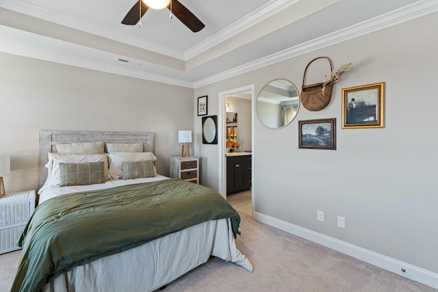 bedroom featuring crown molding, a raised ceiling, light carpet, connected bathroom, and baseboards