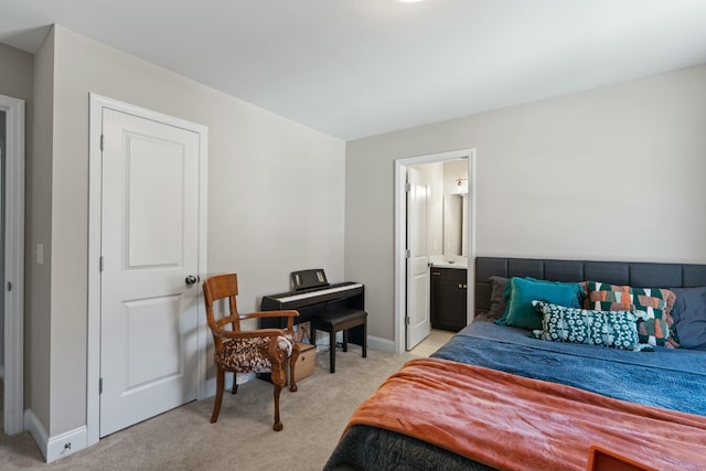 bedroom with light carpet, connected bathroom, and baseboards