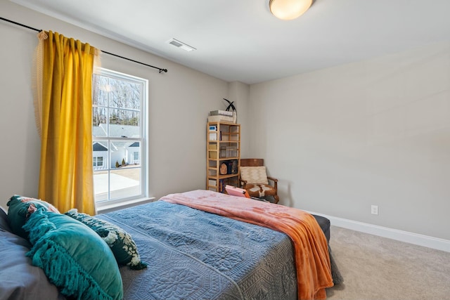 carpeted bedroom featuring visible vents and baseboards