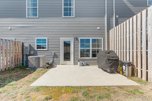 back of house with a patio, central AC unit, and a fenced backyard