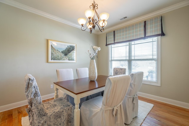 4581 Sweet Berry Ln, Ooltewah, TN 37363 - dining space featuring a chandelier, crown molding, plenty of natural light, and light wood-type flooring