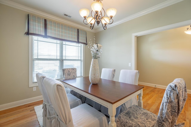 4581 Sweet Berry Ln, Ooltewah, TN 37363 - dining space featuring a chandelier, crown molding, and light wood-style floors