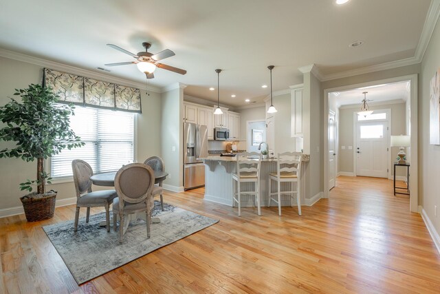 4581 Sweet Berry Ln, Ooltewah, TN 37363 - dining space with ceiling fan, light wood finished floors, ornamental molding, and recessed lighting