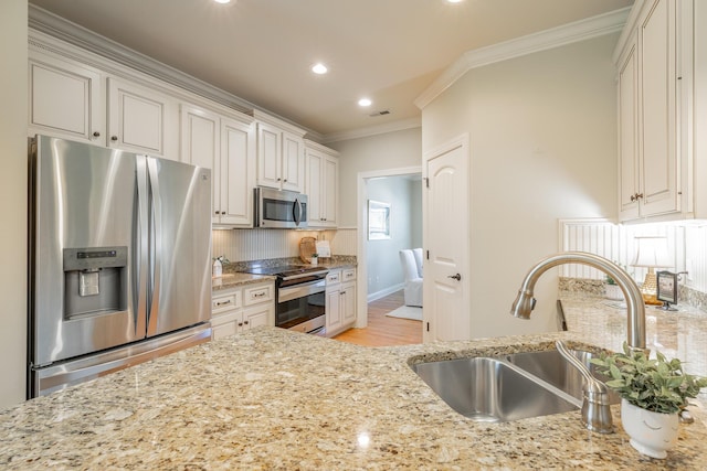 4581 Sweet Berry Ln, Ooltewah, TN 37363 - kitchen with appliances with stainless steel finishes, decorative backsplash, crown molding, light stone counters, and recessed lighting