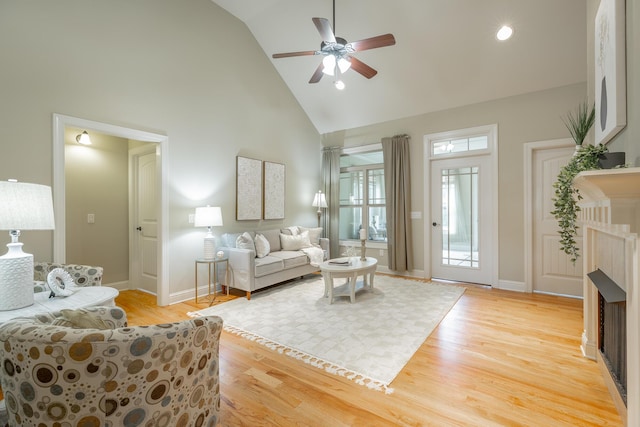 4581 Sweet Berry Ln, Ooltewah, TN 37363 - living area with high vaulted ceiling, ceiling fan, a fireplace, and light wood finished floors