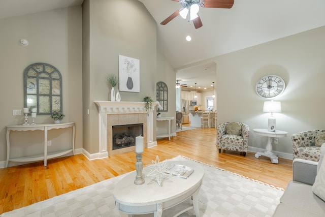 4581 Sweet Berry Ln, Ooltewah, TN 37363 - living area featuring a ceiling fan, high vaulted ceiling, wood finished floors, a tile fireplace, and recessed lighting