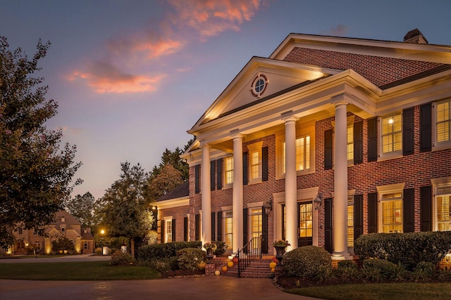 greek revival inspired property with brick siding