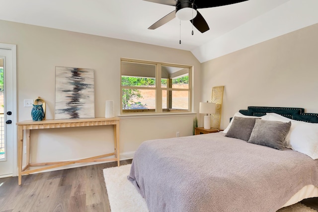 bedroom featuring lofted ceiling, wood finished floors, and a ceiling fan