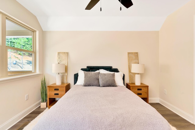 bedroom featuring dark wood-style floors, lofted ceiling, ceiling fan, and baseboards