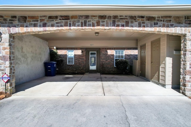 exterior space featuring an attached carport and concrete driveway