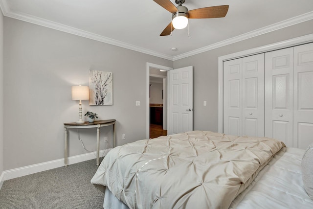 bedroom with ornamental molding, a ceiling fan, a closet, carpet flooring, and baseboards