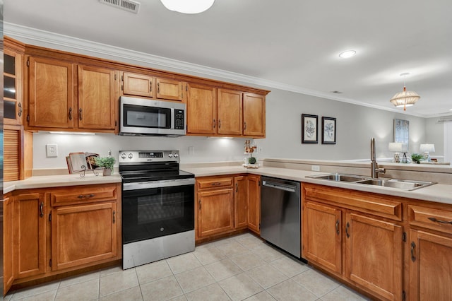 kitchen featuring a sink, ornamental molding, brown cabinetry, and stainless steel appliances