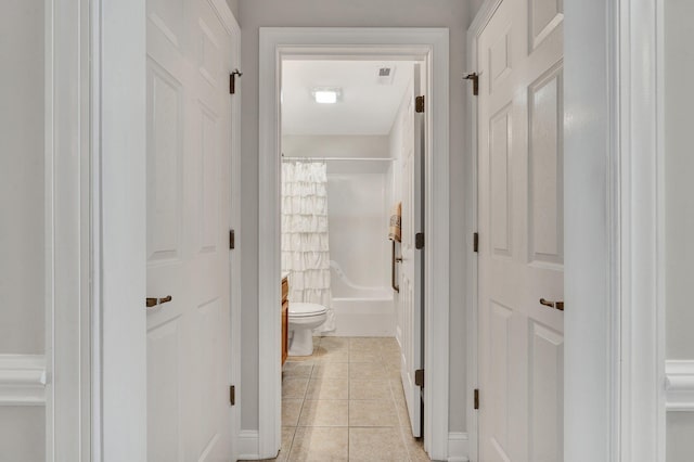 hall with light tile patterned floors