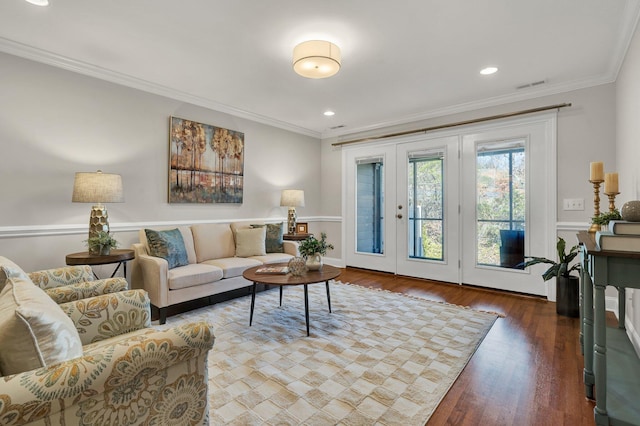 living area with recessed lighting, wood finished floors, visible vents, and ornamental molding