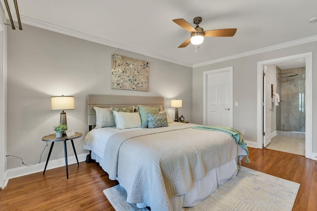 bedroom with baseboards, wood finished floors, and crown molding