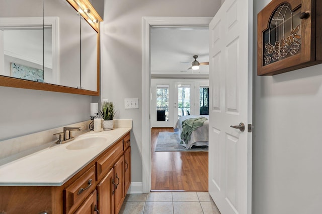 bathroom featuring tile patterned floors, baseboards, vanity, and ceiling fan