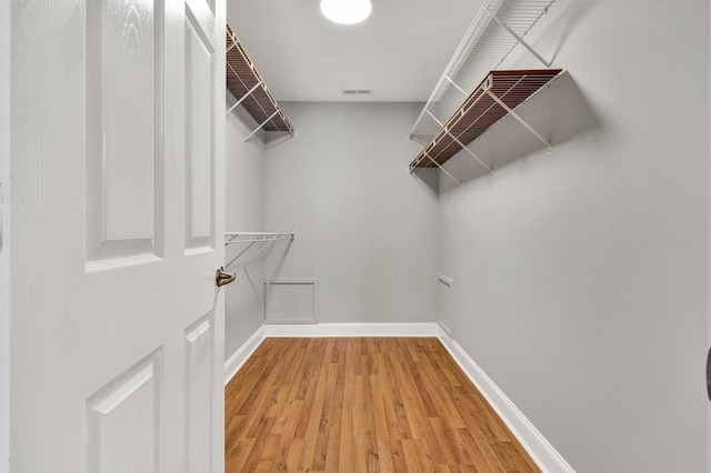 walk in closet featuring visible vents and light wood-type flooring