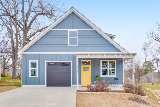 view of front of home with a porch, a garage, board and batten siding, and driveway