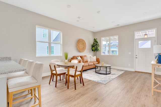 living room featuring baseboards and light wood-style floors