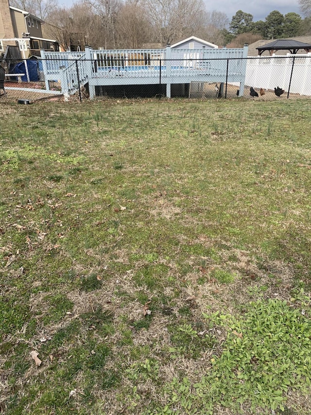 view of yard with fence and a wooden deck