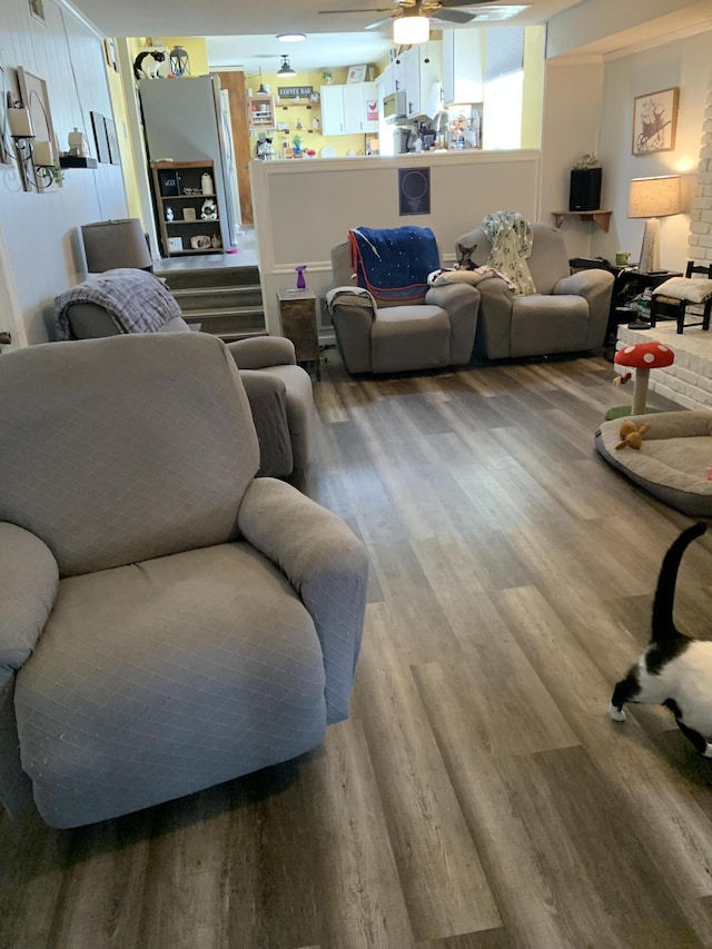 living room with ceiling fan and wood finished floors