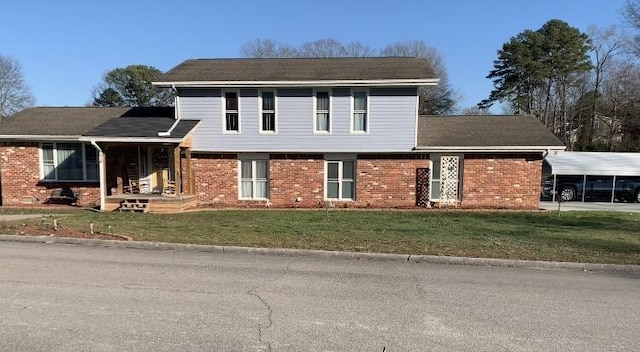 tri-level home with brick siding and a front yard