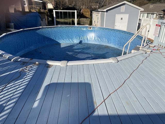 view of pool featuring a wooden deck and an empty pool