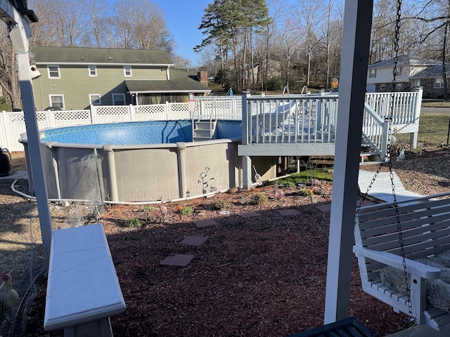 view of pool with a fenced in pool, a deck, and fence