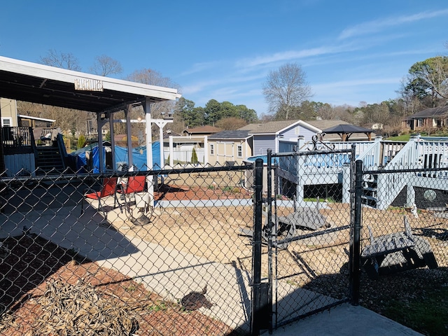 view of yard featuring a gate, a residential view, and fence