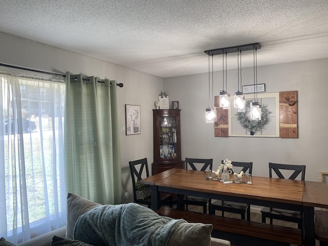 dining area featuring a textured ceiling