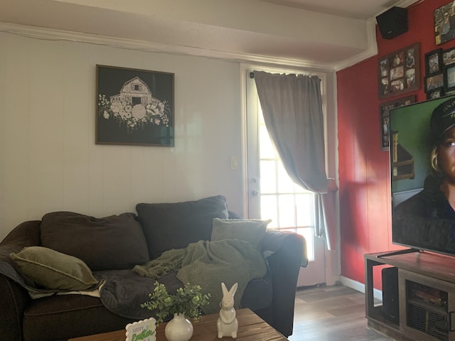 living room with wood finished floors and ornamental molding