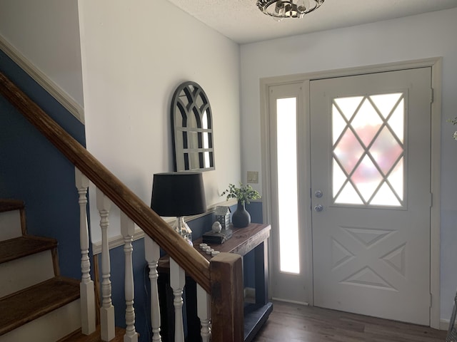 entryway with stairs and wood finished floors