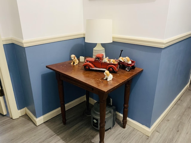 dining space with light wood finished floors and baseboards