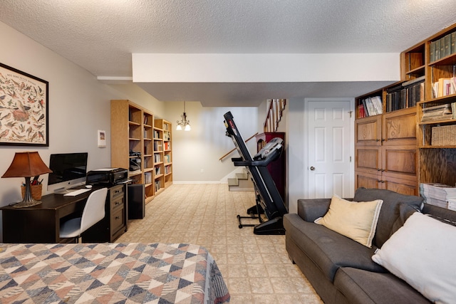 bedroom with a textured ceiling, light floors, and baseboards