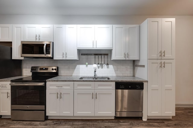 kitchen featuring stainless steel appliances, white cabinets, and a sink