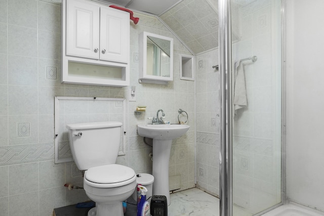 full bathroom with toilet, a sink, vaulted ceiling, marble finish floor, and a stall shower