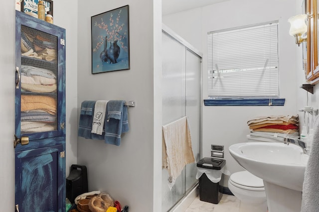 full bath with marble finish floor, an enclosed shower, and toilet