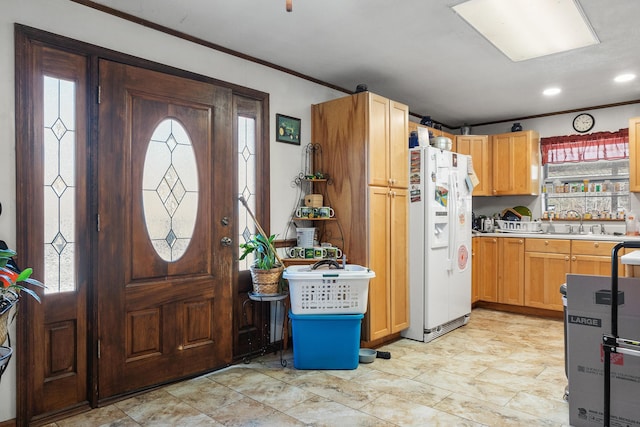 kitchen featuring white fridge with ice dispenser, light countertops, and a wealth of natural light