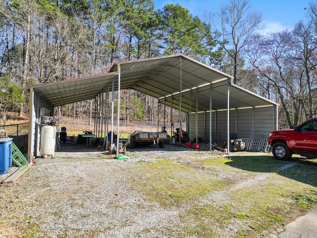 view of parking / parking lot featuring driveway and a detached carport