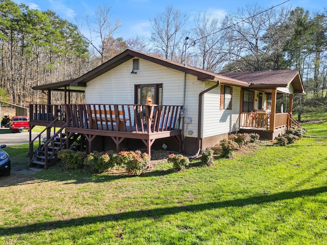 exterior space featuring a front yard and a wooden deck